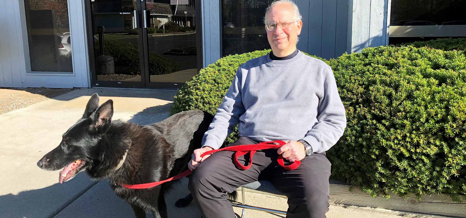 man sitting on bench with a dog
